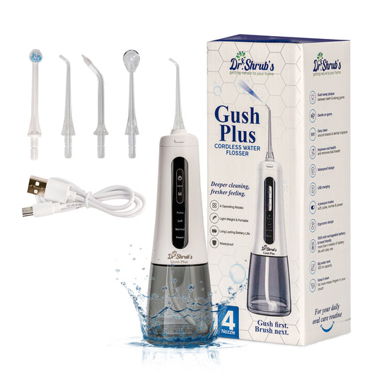 Dr. Shrub's Gush Plus cordless water flosser with packaging, nozzles, and USB cable on a white background